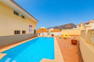 a swimming pool in the backyard of a house at Be six Playa La Arena in Puerto de Santiago