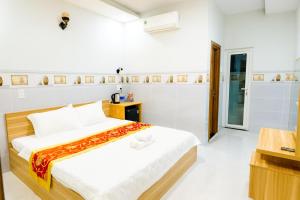 a bedroom with a bed in a room at Moony Hotel Long Thành in Long Thành