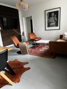 a living room with a couch and a table at Unique & premium apartment with free wifi & parking for 2 cars in the center of Kerava in Kerava