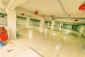 an empty room with columns and a tiled floor at Moony Hotel Long Thành in Long Thành