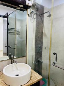 a bathroom with a sink and a shower at Hotel Krishana Palace- Malviya Nagar in Gurgaon