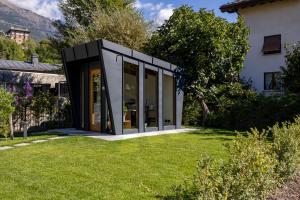 a modern house with glass doors in a yard at Le Grenier d'Antan - Relax Suite in Aosta