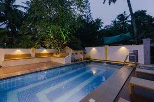 a swimming pool in a resort at night at Pvt Pool - Villa Azura Escape - Casa Marialina 8 BR in Saligao