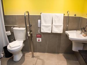 a bathroom with a toilet and a sink at Ibis Styles Garanhuns in Garanhuns +38 photos