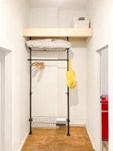 a bunk bed in a room with a shelf at Sunny Renovated Ground-Floor Apartment in Neukölln in Berlin