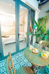 a room with a table and a glass door at Rustic Homestay Bình Dương in Phú Lợi +70 photos