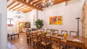 a dining room with a large wooden table and chairs at La Fábrica de Juan Antequera - La Joya by Ruralidays in Antequera