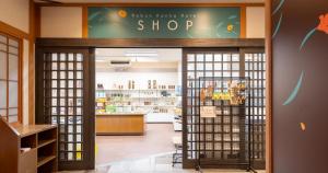 a store entrance with a shop sign on the wall at REBUN Hotel SARYO in Kafuka +126 photos