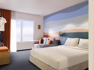 a hotel room with a bed and a window at Ibis Styles Miramas in Miramas +99 photos