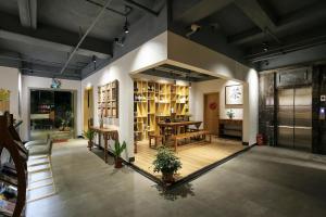 a large room with a table and chairs and shelves at Yangshuo Tea House Inn - By West Street and Li River in Yangshuo