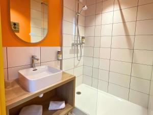 a bathroom with a sink and a shower at greet hotel Castets Coeur des Landes in Castets +80 photos
