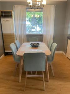 a dining room table with chairs and a bowl on it at A Pet Friendly Subic Bay Vacation Home in Olongapo +8 photos