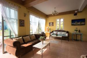 a living room with a couch and a table at Doi Tung View Resort in Mae Sai