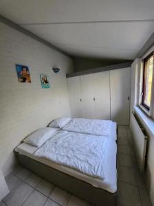 a bedroom with a bed in the corner of a room at Bungalow 002 in Petten