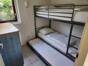 a small room with two bunk beds in it at Bungalow 002 in Petten