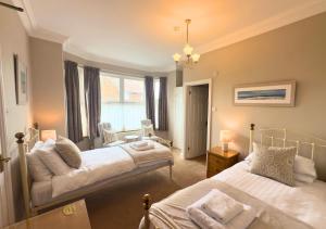 a bedroom with two beds and a window at Rose-Fitt House in Hunstanton