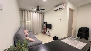 un soggiorno con un divano e un tavolo di Ether 665 Homestay a Sekincan