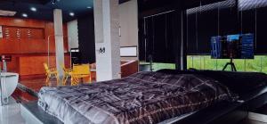 a bedroom with a large bed and a table and chairs at Lanmuanghouse in Ban Pa Kluai