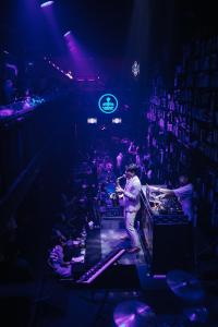 a man standing on a stage in front of a crowd at Lanmuanghouse in Ban Pa Kluai