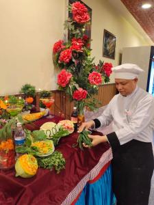 a chef preparing food at a table with vegetables at Hotel Sun Star International Pvt Ltd in Bhairāhawā +85 photos