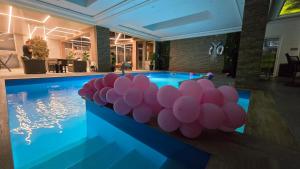 a pool with a bunch of pink balloons on it at Bazen za uzivanje in Petrovaradin +5 photos