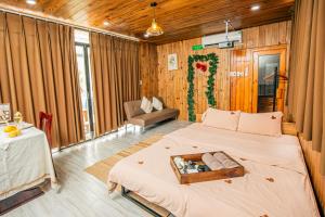 a bedroom with a bed with a tray on it at Rustic Homestay Bình Dương in Phú Lợi