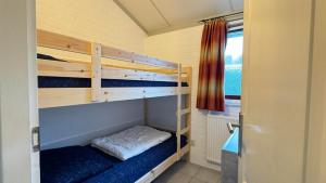a room with two bunk beds and a window at Bungalow 028 in Petten
