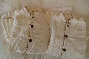 two white jackets are hanging on a bed at 住京都小川生薬ヴィラ Jyu KyotoOgawasyouyaku VILLA in Kyoto +6 photos