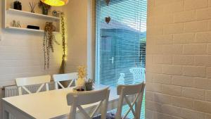 a dining room with a table and chairs and a window at Bungalow 028 in Petten