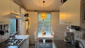 a small kitchen with a table and a stove at Bungalow 028 in Petten