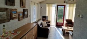 a living room with a couch and a table at Bungalow 038 in Petten