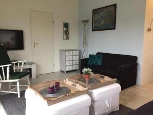 a living room with a couch and a table at Bungalow 040 in Petten