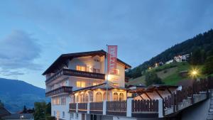 a building with a sign on the side of it at Pitztal Living Apartments in Jerzens