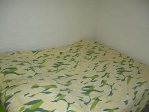 a bed with a bedsheet with fish on it at Bungalow 052 in Petten
