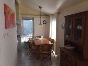 a kitchen and dining room with a table and chairs at Bungalow 052 in Petten