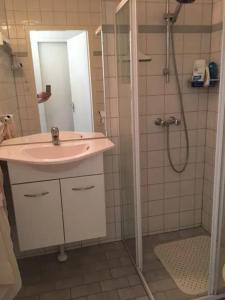 a bathroom with a sink and a shower at Bungalow 052 in Petten