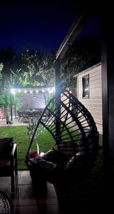 a circular swing in a yard at night at Chalet 5 in Petten