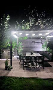 a table and chairs on a patio at night at Chalet 5 in Petten