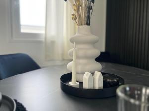 a white vase sitting on top of a table at Chalet 5 in Petten