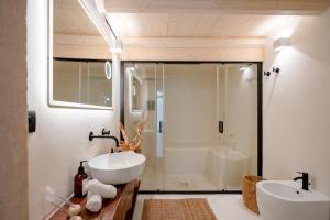 a bathroom with a tub and a sink and a shower at Archè Luxury private Spa in Polignano a Mare