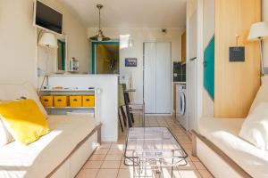 a living room with a white couch and a glass table at Appartement en rdc - résidence la Goëlette Port Bourgenay - 4 personnes in Saint-Jean-dʼOrbetiers
