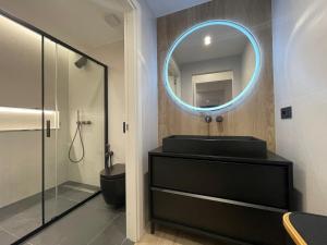 a bathroom with a sink and a mirror at Azulis Terme Suite 1 - luxury renovated accommodation in Olbia Center with garden in Olbia