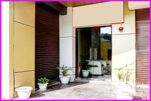a group of potted plants sitting outside of a building at Hotel Chankaya BNR Palace - Jagannath Temple - Sea Beach - Swimming Pool- Restaurant - Lift And Parking Facilities - Fully Air Condition with All Luxury Luxuary Rooms With Attached-Balcony - A Top Rated Hotel in Kathmandu