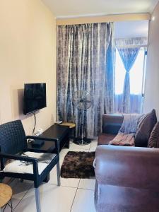 a living room with a couch and a table at Palm Rest in Pretoria