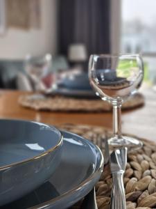 a table with a glass of wine on a table at Chalet 82 in Petten
