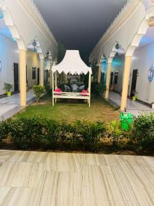 a white gazebo in the courtyard of a building at Hotel Mewad Haveli Pushkar in Pushkar