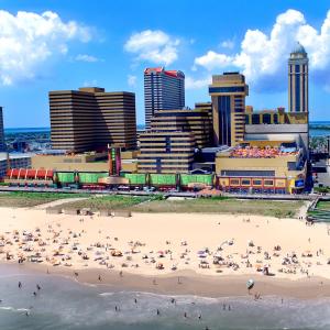 a group of people on a beach in front of a city at Tropicana Casino and Resort in Atlantic City