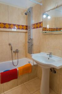 a bathroom with a sink and a shower and a tub at Vrokastro Apartments in Istro