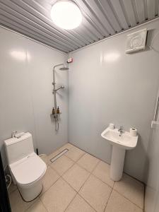 a bathroom with a toilet and a sink at Sunset Hill Cabins in San Fabian