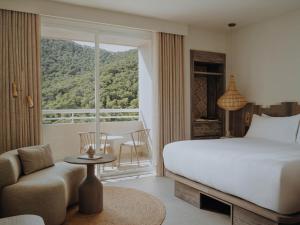 a bedroom with a bed and a room with a window at Hyde Hotel Ibiza Beach Resort by ACCOR in Cala Llonga +251 photos